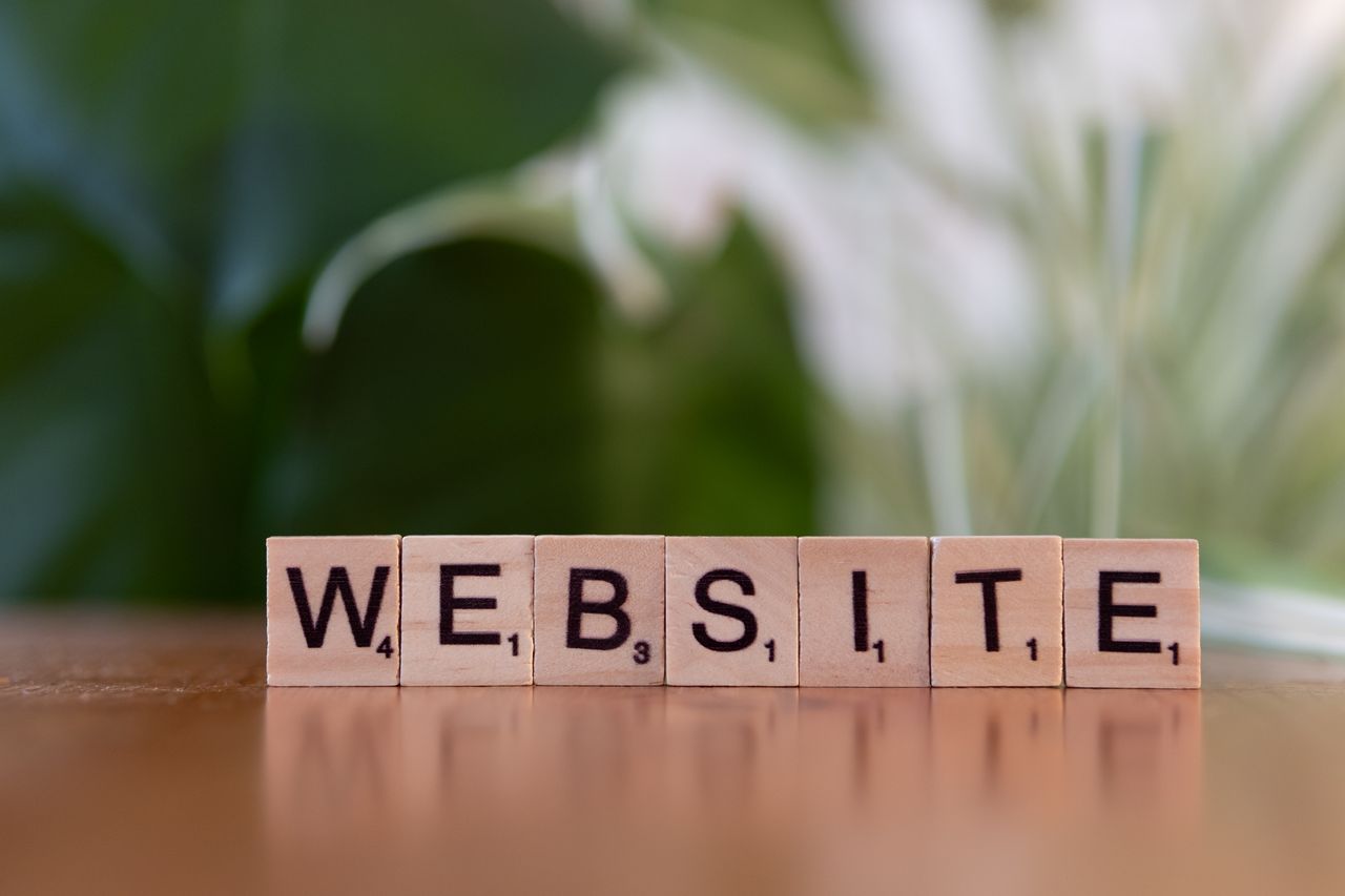 Crafting Captivating Headlines: Your awesome post title goes here Scrabble tiles on a wooden surface forming the word 'Website', symbolizing digital communication.